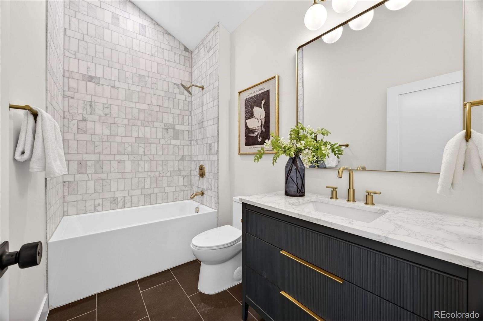 5175 Raleigh Street Denver, CO 80212 - Photo 23 of 49 a bathroom with a granite countertop bathtub sink vanity mirror and toilet