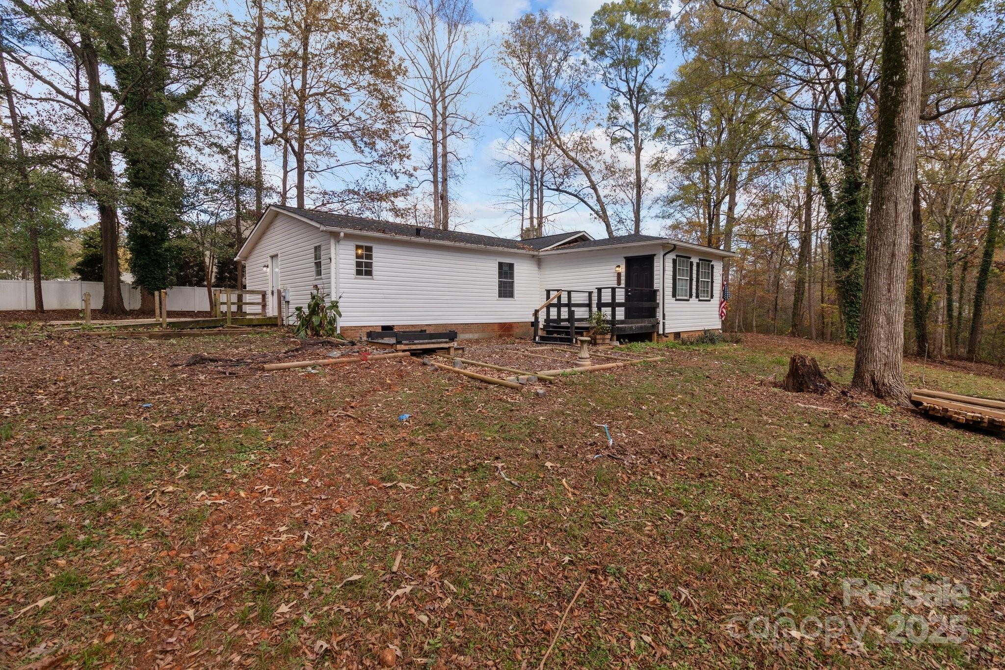 4642 McClure Road Charlotte, NC 28216 - Photo 23 of 48 a view of a house with a large tree in front of a house