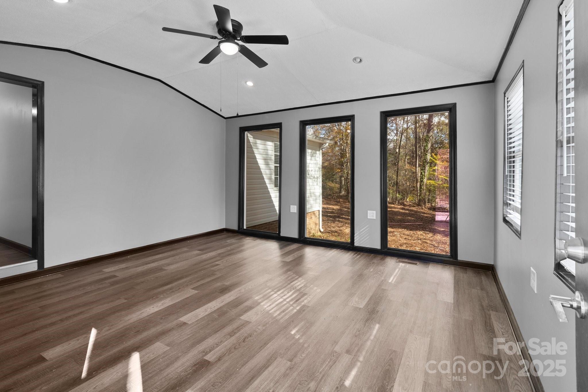 4642 McClure Road Charlotte, NC 28216 - Photo 25 of 48 a view of an empty room with a window and wooden floor