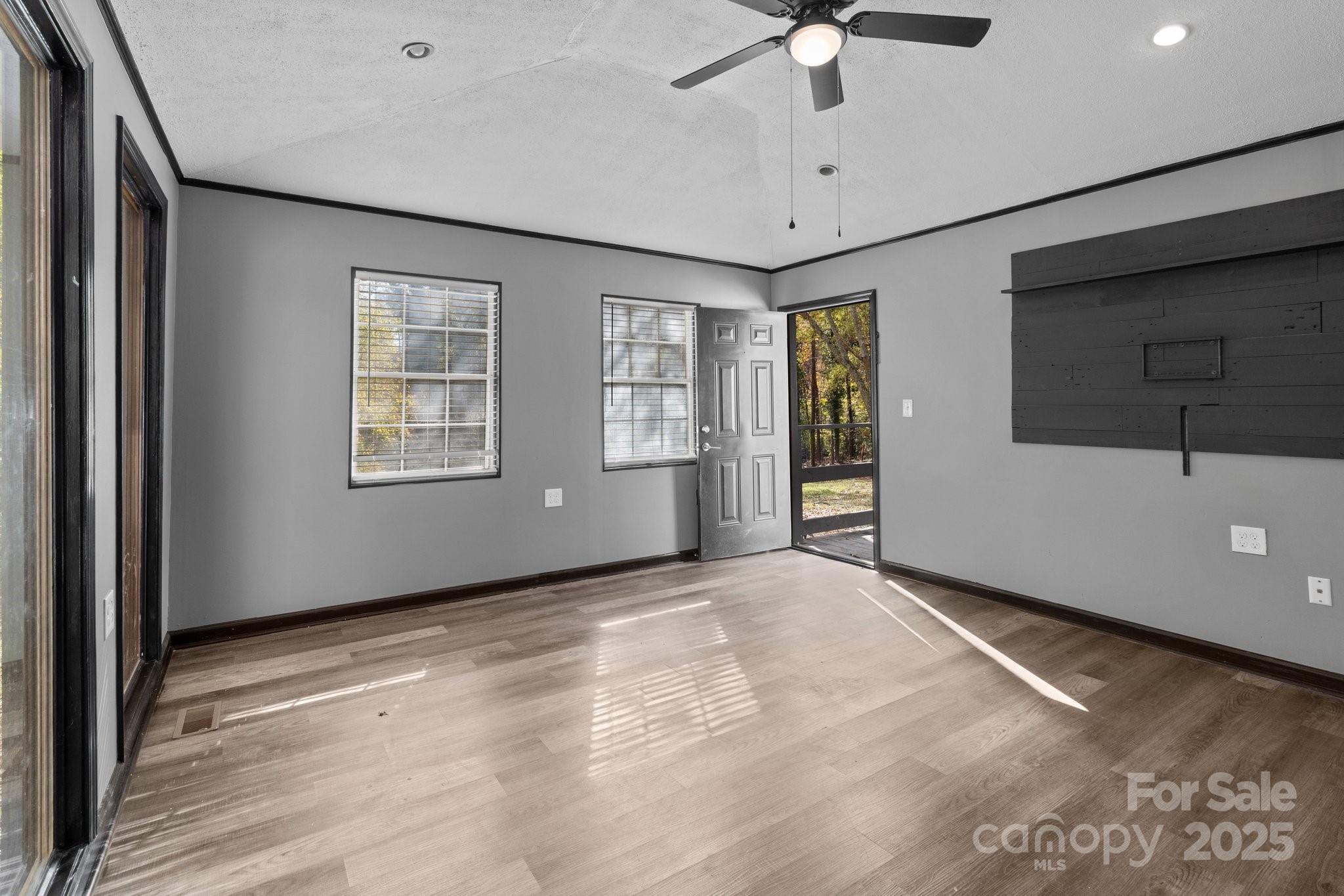 4642 McClure Road Charlotte, NC 28216 - Photo 26 of 48 a view of an empty room with a window and a ceiling fan
