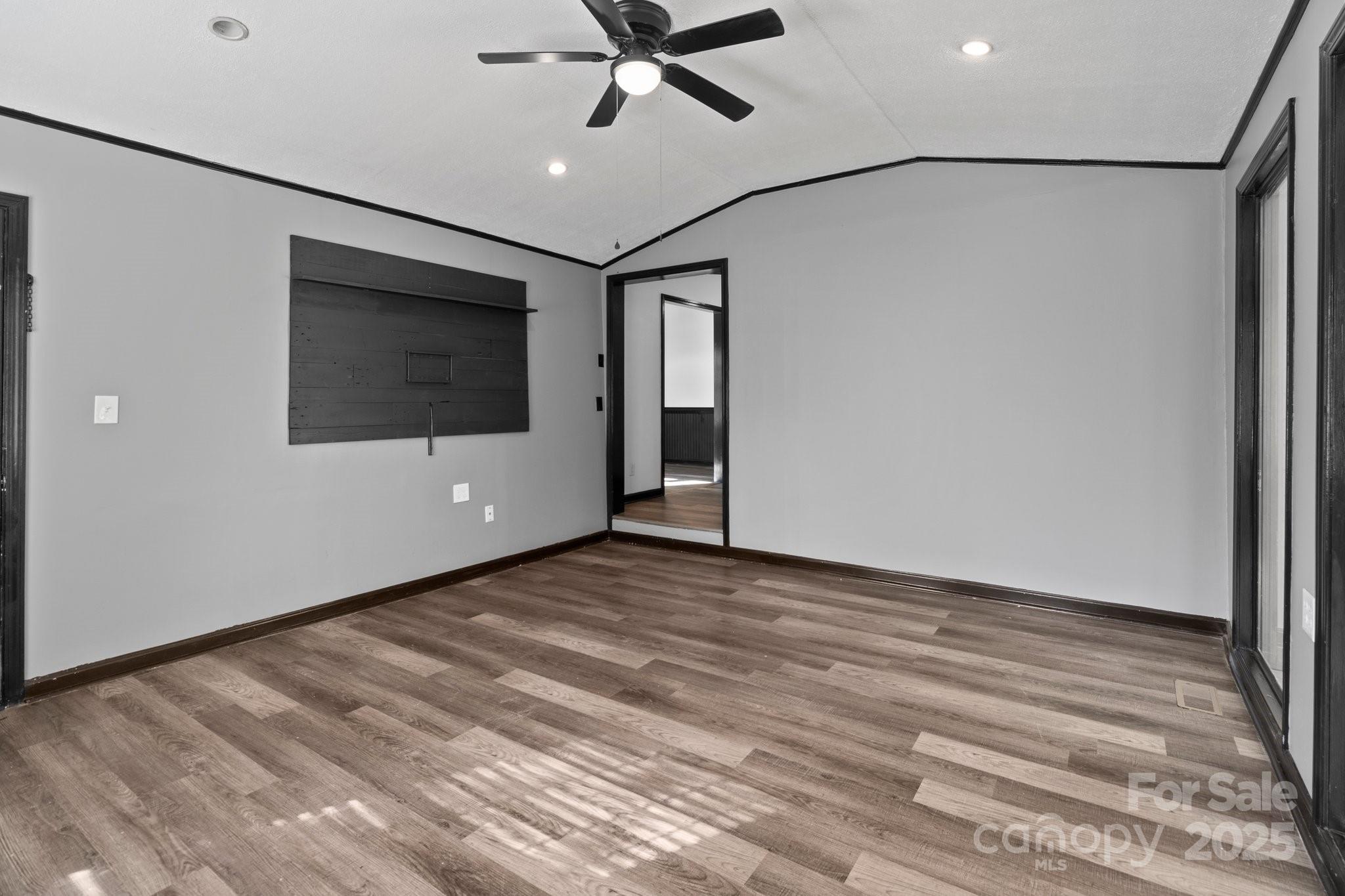 4642 McClure Road Charlotte, NC 28216 - Photo 27 of 48 a view of an empty room with wooden floor and a window
