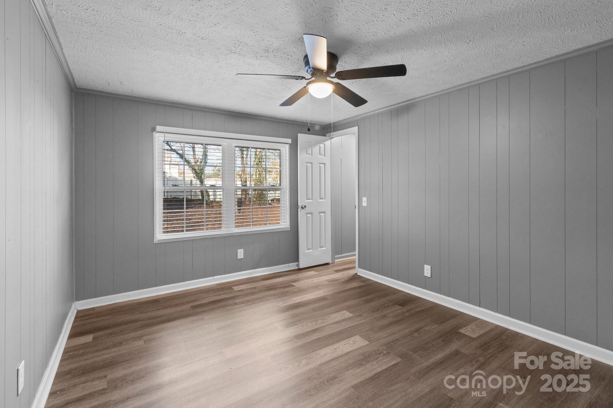 4642 McClure Road Charlotte, NC 28216 - Photo 30 of 48 a view of an empty room with wooden floor and a window