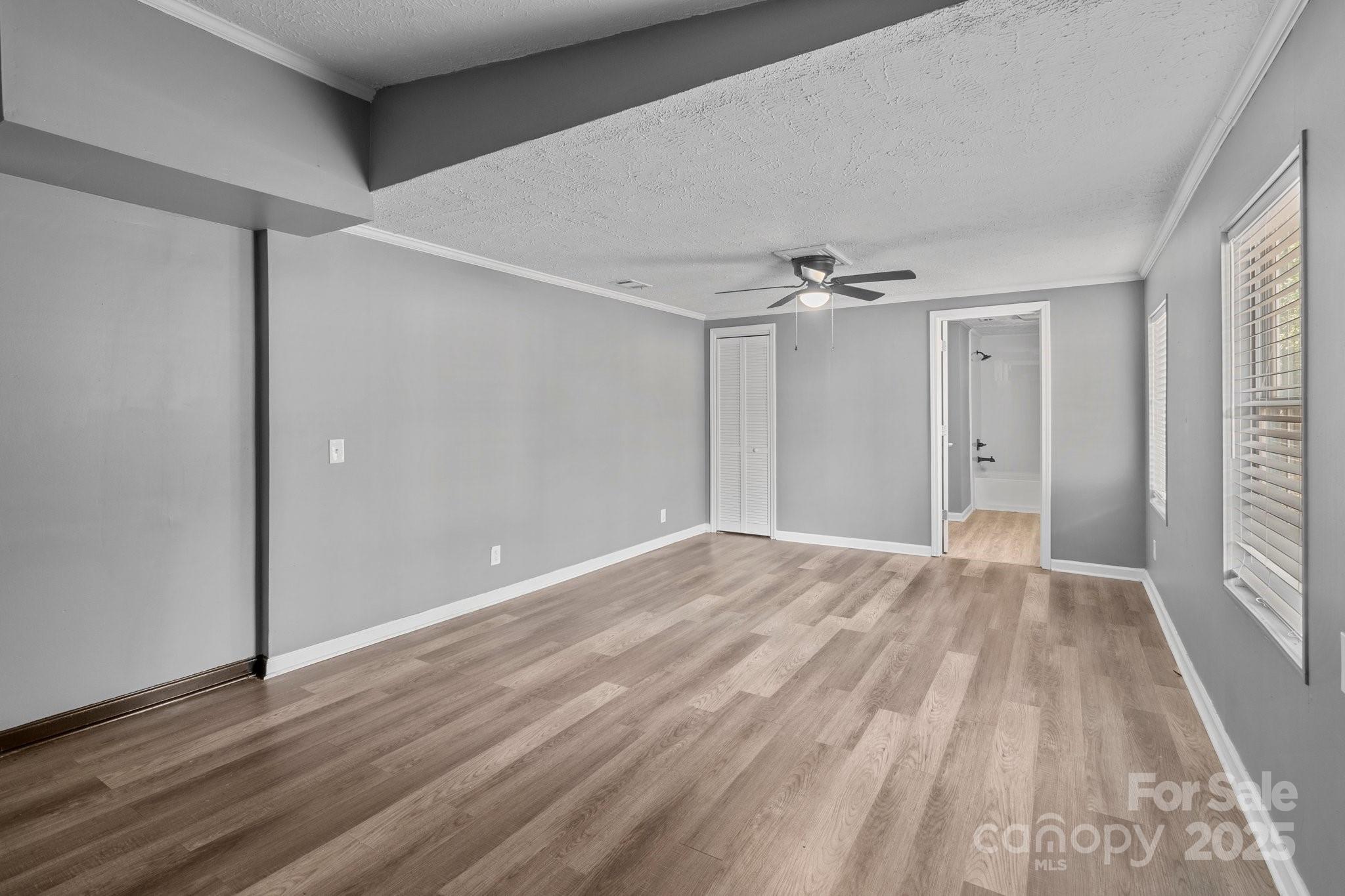 4642 McClure Road Charlotte, NC 28216 - Photo 36 of 48 a view of a big room with wooden floor and windows in a room