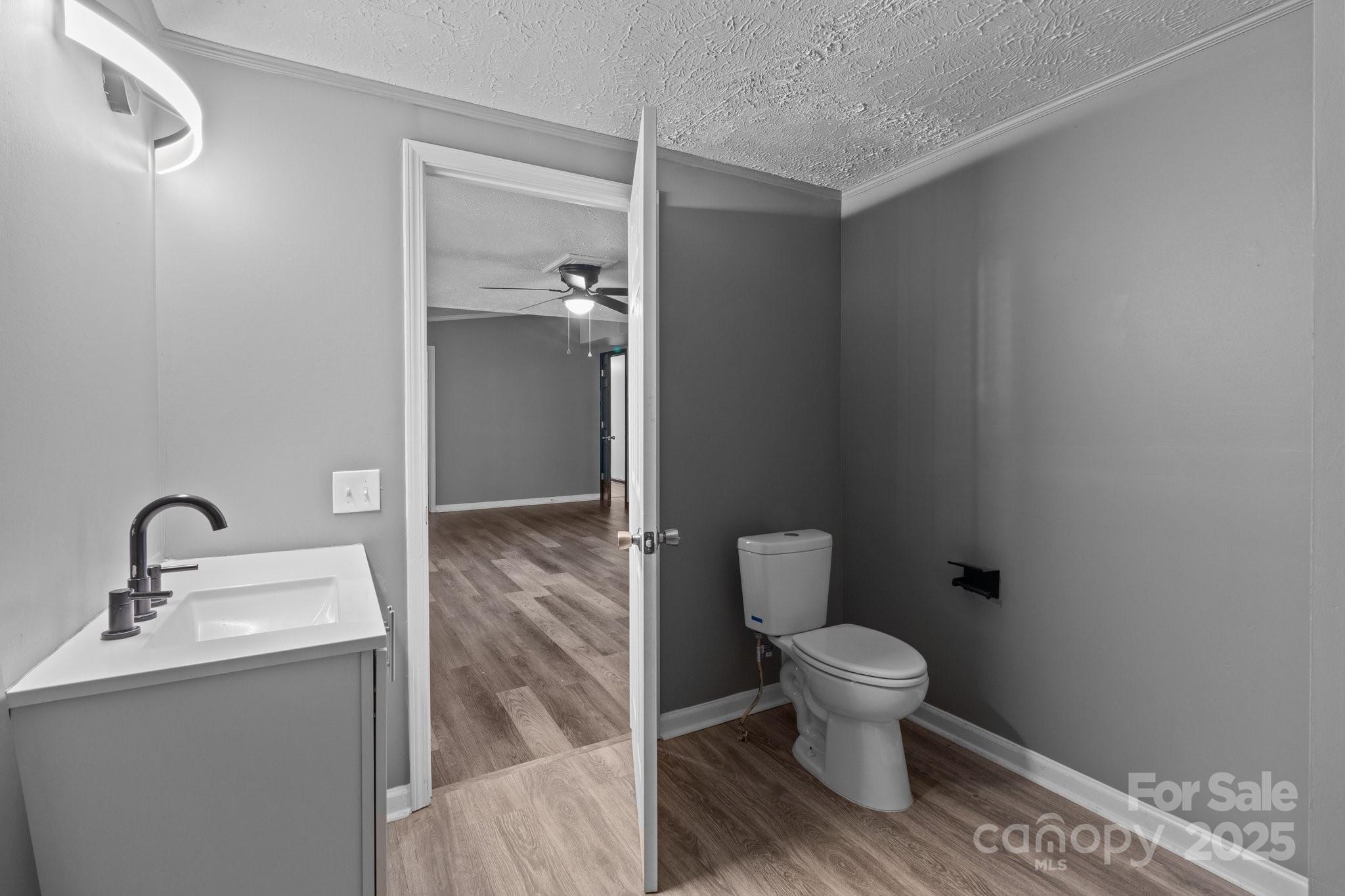 4642 McClure Road Charlotte, NC 28216 - Photo 40 of 48 a bathroom with a toilet sink and mirror