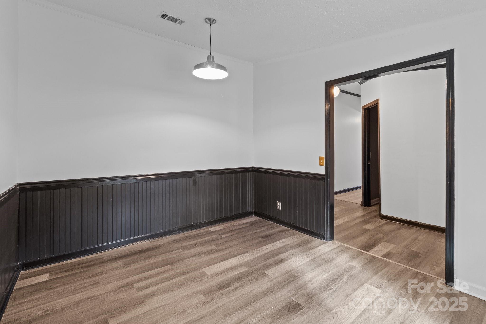 4642 McClure Road Charlotte, NC 28216 - Photo 43 of 48 a view of an empty room with wooden floor