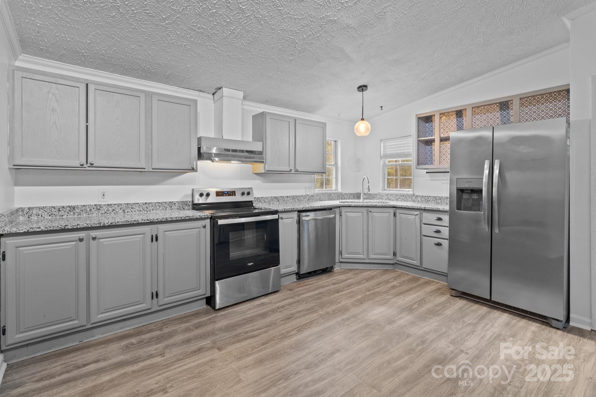 4642 McClure Road Charlotte, NC 28216 - Photo 45 of 48 a kitchen with stainless steel appliances granite countertop a stove a sink and a refrigerator