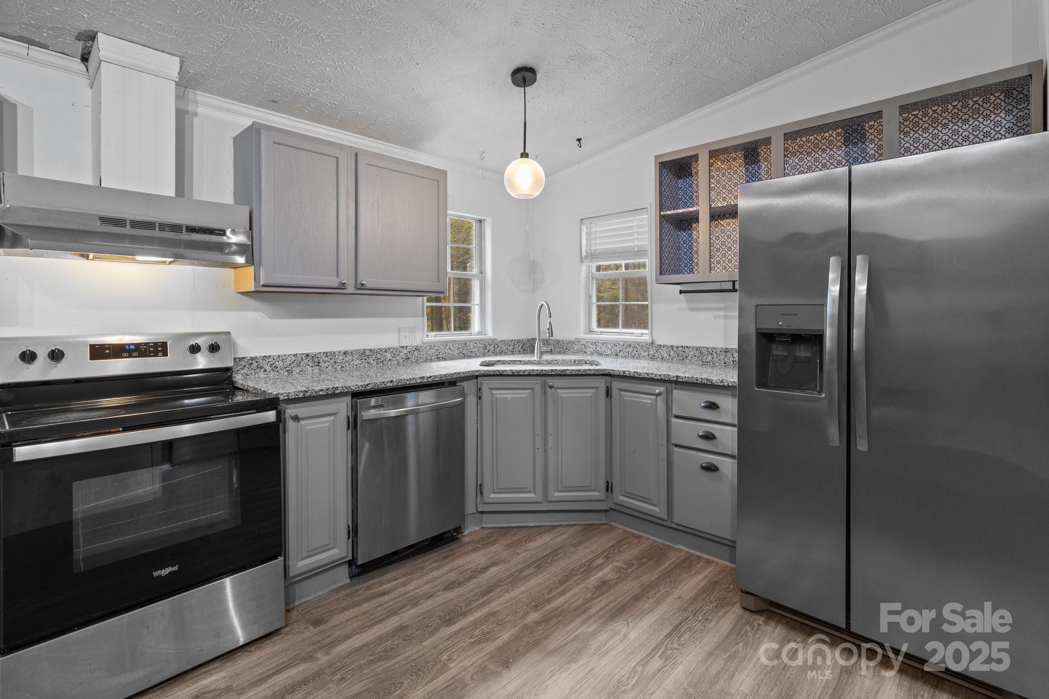 4642 McClure Road Charlotte, NC 28216 - Photo 46 of 48 a kitchen with stainless steel appliances granite countertop a stove a refrigerator and a sink
