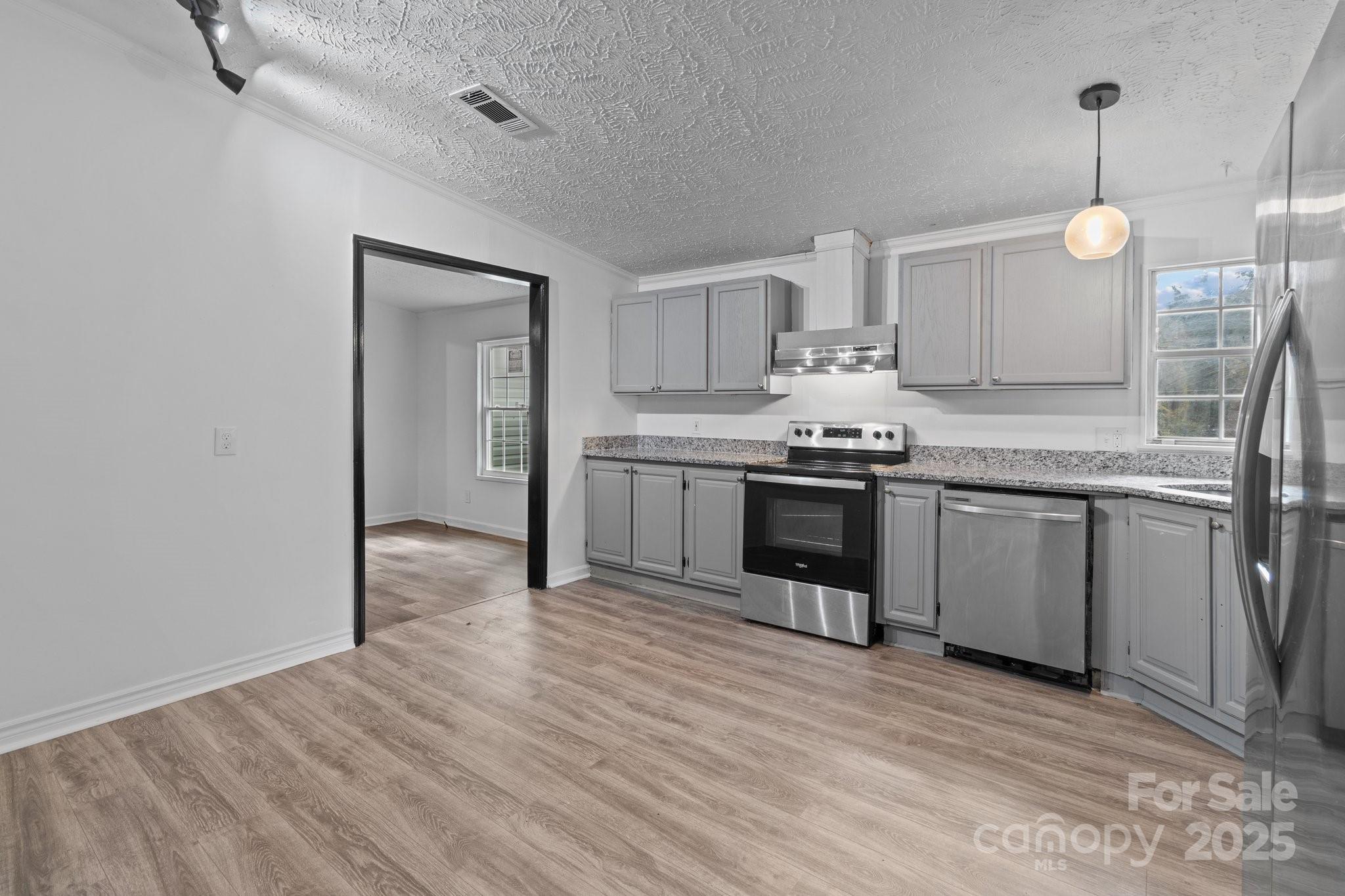 4642 McClure Road Charlotte, NC 28216 - Photo 47 of 48 a kitchen with stainless steel appliances granite countertop a stove a sink dishwasher and a refrigerator with wooden floor