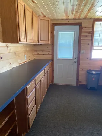a kitchen with sink cabinets and window