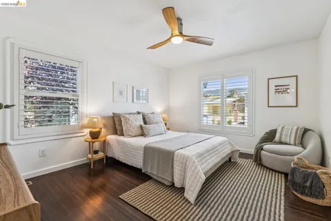a bedroom with a bed a couch and a window