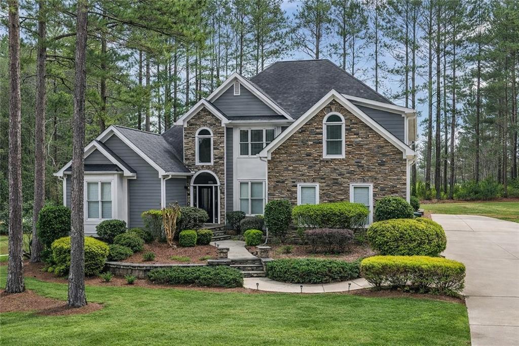 a front view of house with a garden