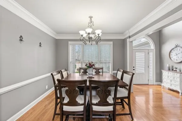 a view of a dining room with furniture and wooden floor