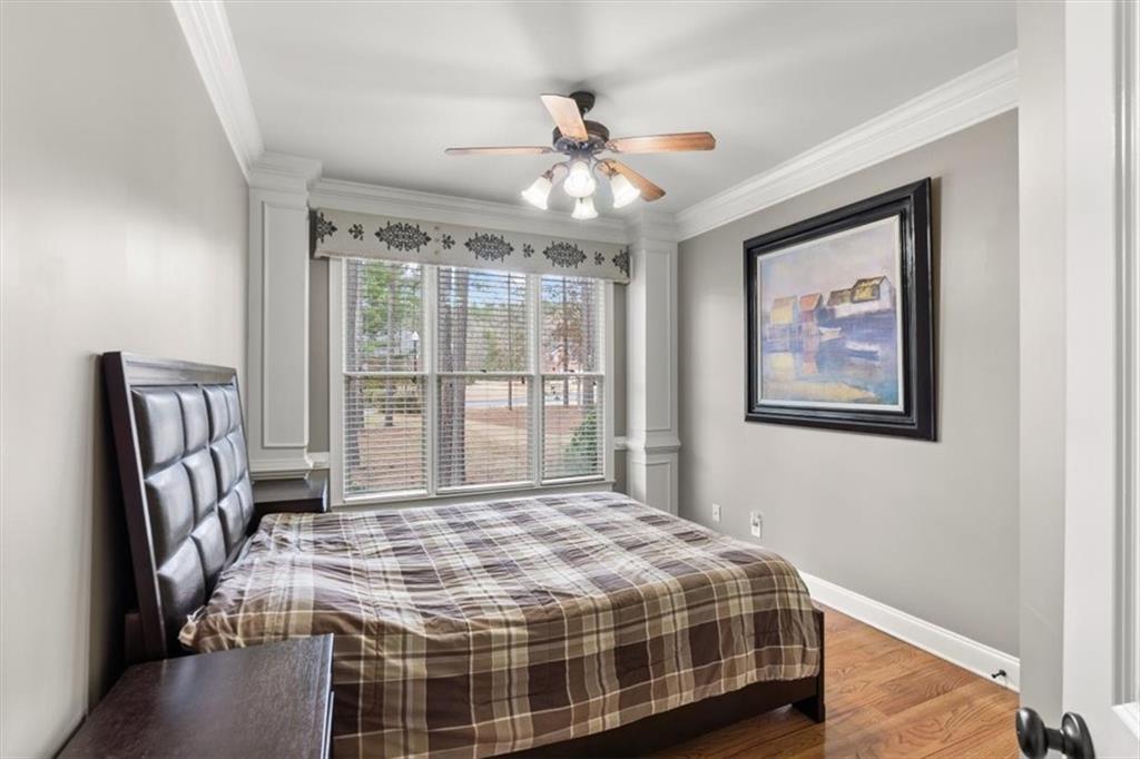 18 Nelson Boulevard Northwest Rome, GA 30165 - Photo 21 of 41 a bedroom with a large bed and a chandelier