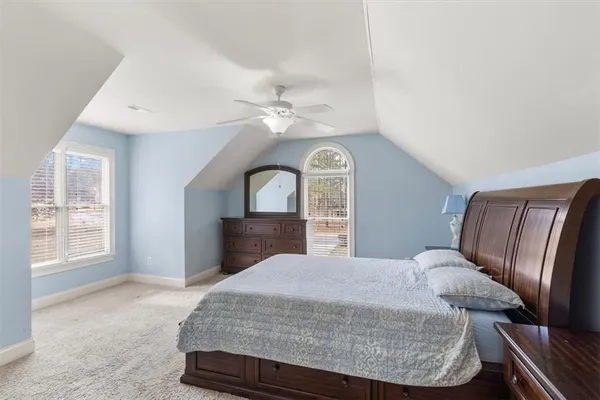 a living room with a bed furniture and a window