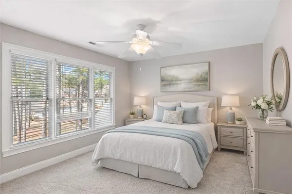 a bedroom with a large bed and a chandelier