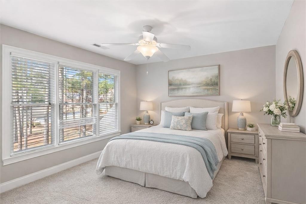 18 Nelson Boulevard Northwest Rome, GA 30165 - Photo 29 of 41 a bedroom with a large bed and a chandelier