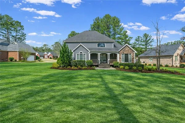 a front view of a house with a yard table and chairs