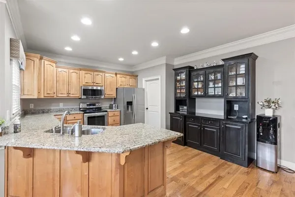 a kitchen with stainless steel appliances granite countertop a sink stove and refrigerator