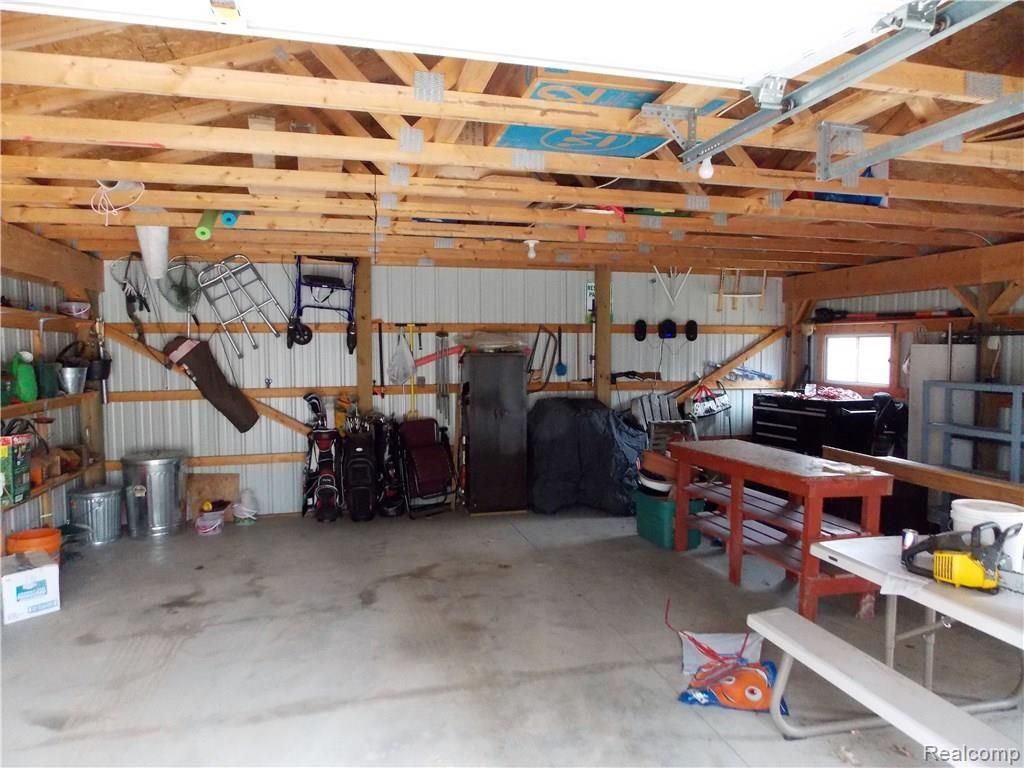1200 North Maple Leaf Road Lapeer, MI 48446 - Photo 22 of 22 Dad may also need a place to hang out. This is the interior of the garage, however there is also a storage shed for mowers and quads.