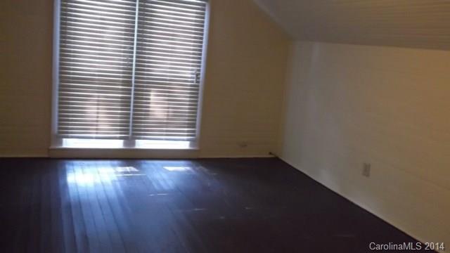 8500 Old Concord Road Charlotte, NC 28213 - Photo 12 of 15 an empty room with wooden floor and a window with blinds