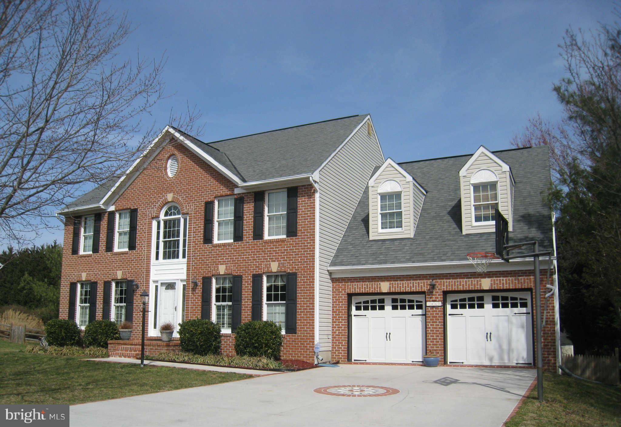 1465 Old Hickory Road Annapolis, MD 21409 - Photo 1 of 30 a front view of a house with a yard and garage