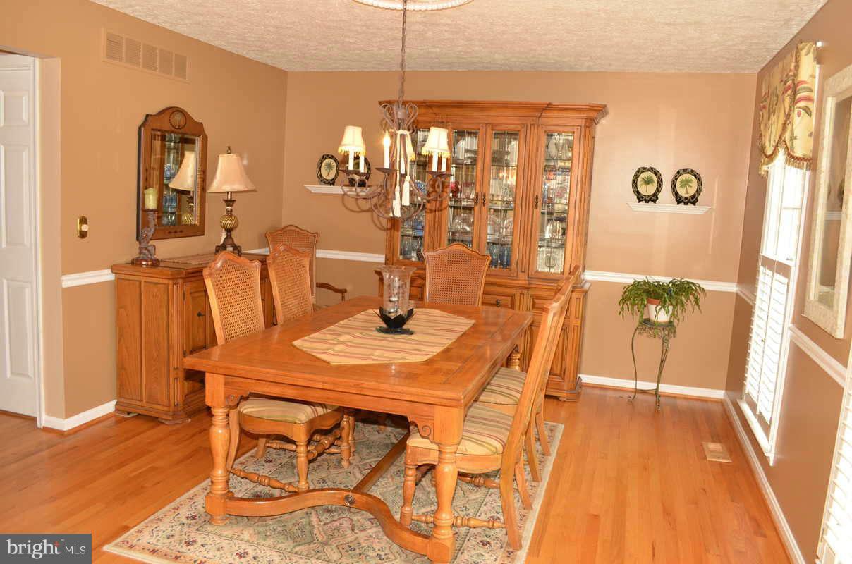 1465 Old Hickory Road Annapolis, MD 21409 - Photo 13 of 30 a view of a dining room with furniture and wooden floor