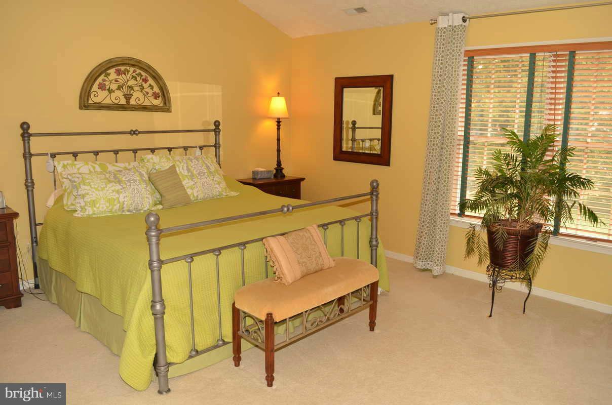 1465 Old Hickory Road Annapolis, MD 21409 - Photo 17 of 30 a bedroom with a bed and a table in it