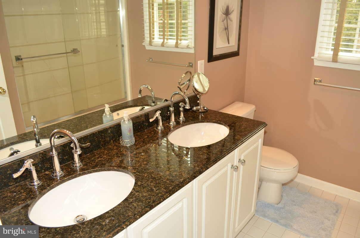 1465 Old Hickory Road Annapolis, MD 21409 - Photo 22 of 30 a bathroom with a granite countertop sink and a mirror
