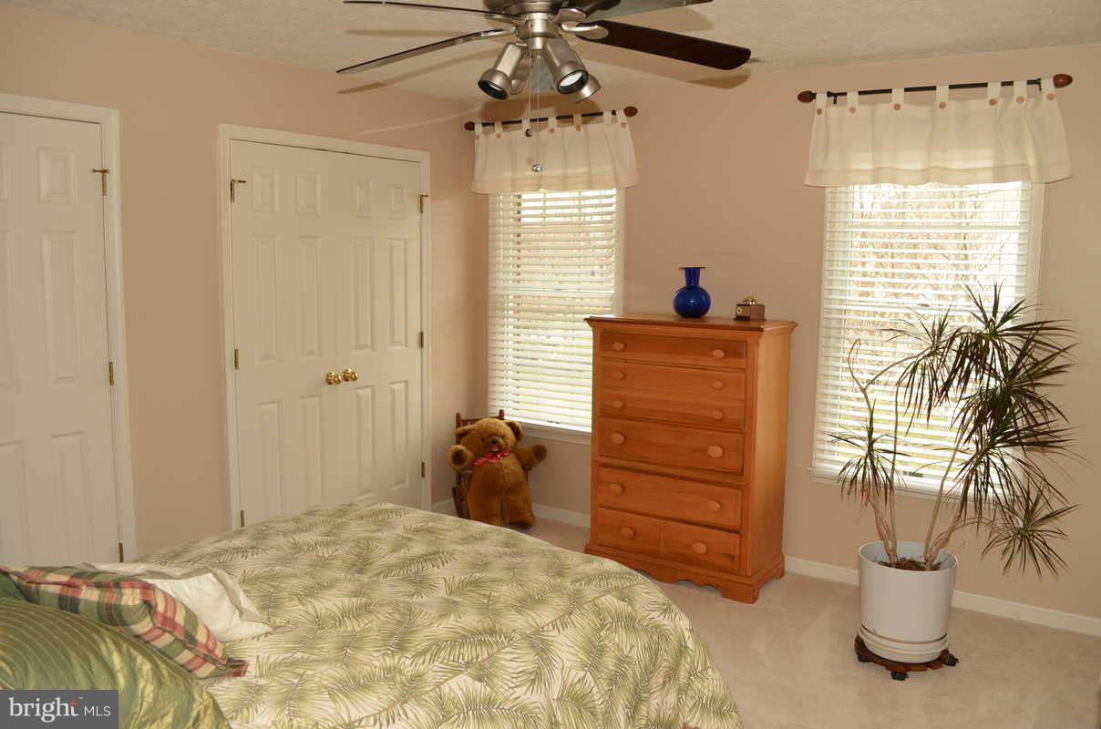 1465 Old Hickory Road Annapolis, MD 21409 - Photo 24 of 30 a bedroom with a bed and a chandelier