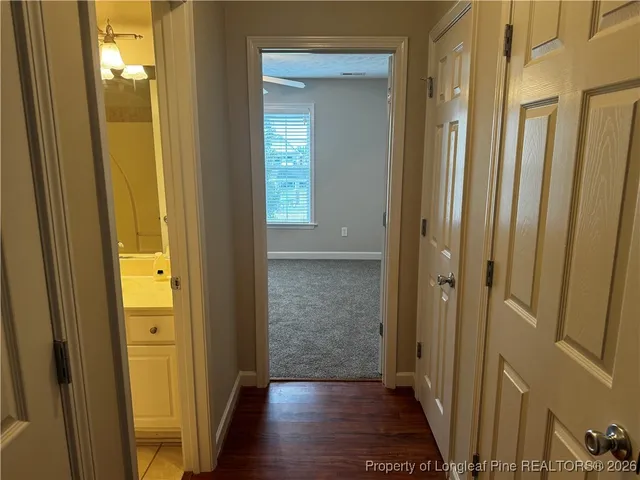 a view of a hallway with wooden floor