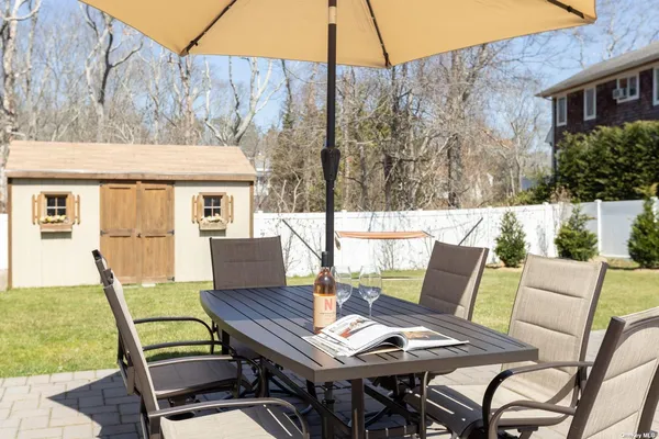 a view of a patio with a table and chairs