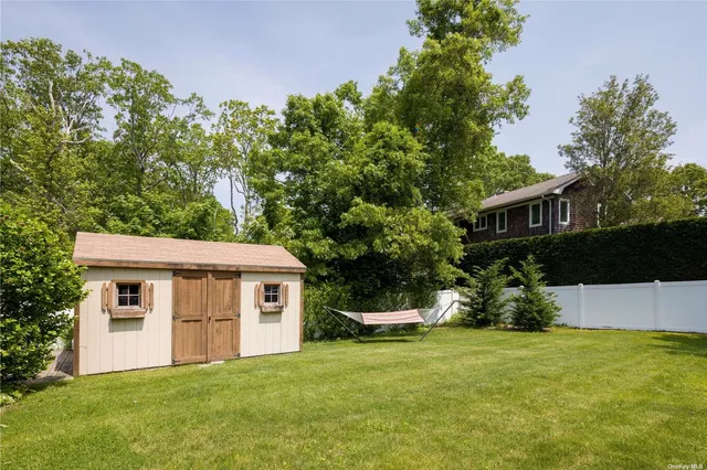 a view of a house with a yard and sitting area