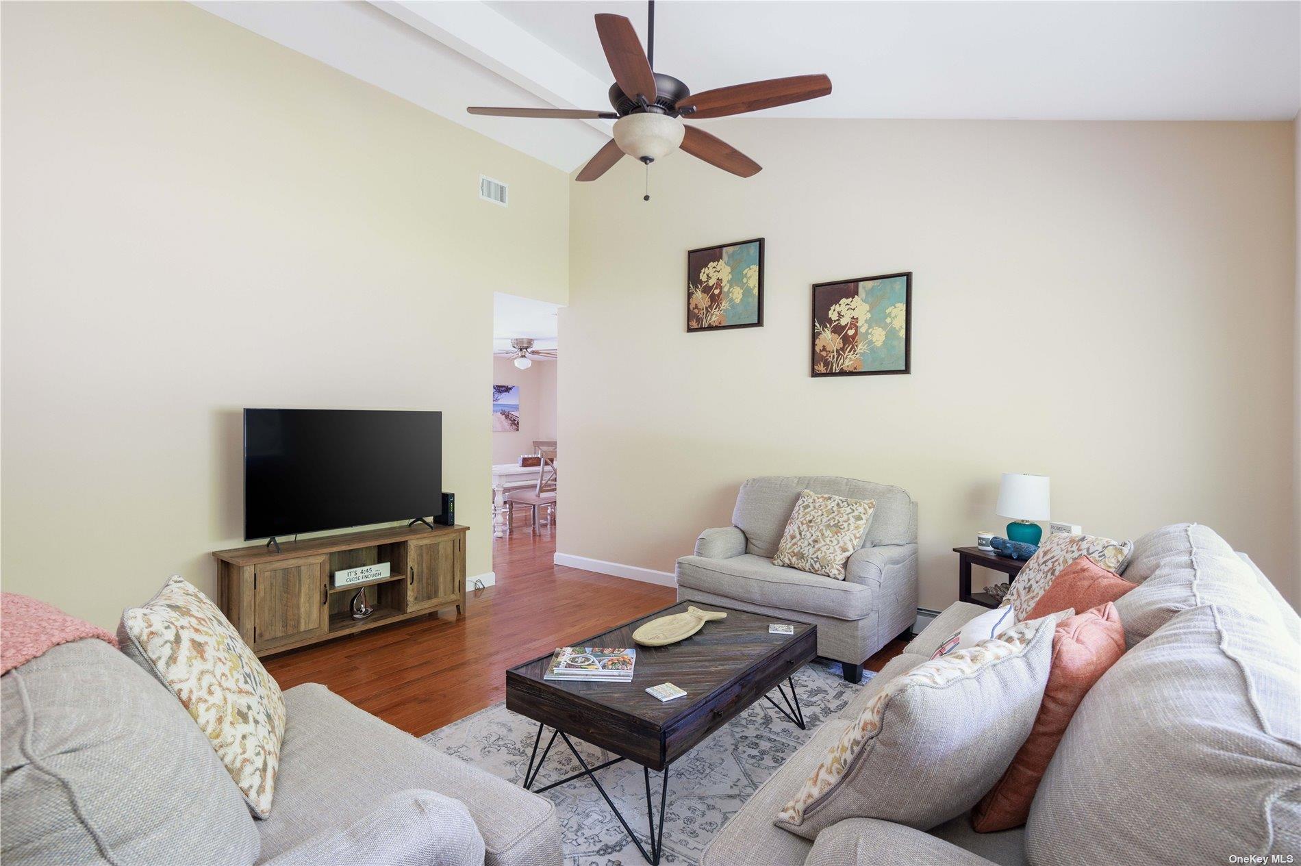 400 Wells Road Laurel, NY 11948 - Photo 3 of 17 a living room with furniture and a flat screen tv