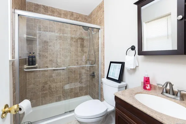 a bathroom with a sink toilet and shower