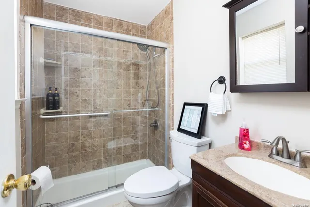 a bathroom with a sink toilet and shower