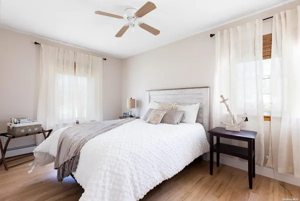a bedroom with a bed a window and a chandelier