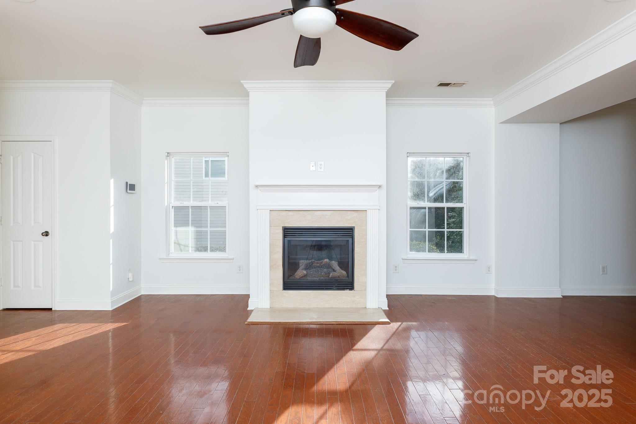780 Ivy Trail Way Fort Mill, SC 29715 - Photo 4 of 14 a view of an empty room with wooden floor fireplace and a window