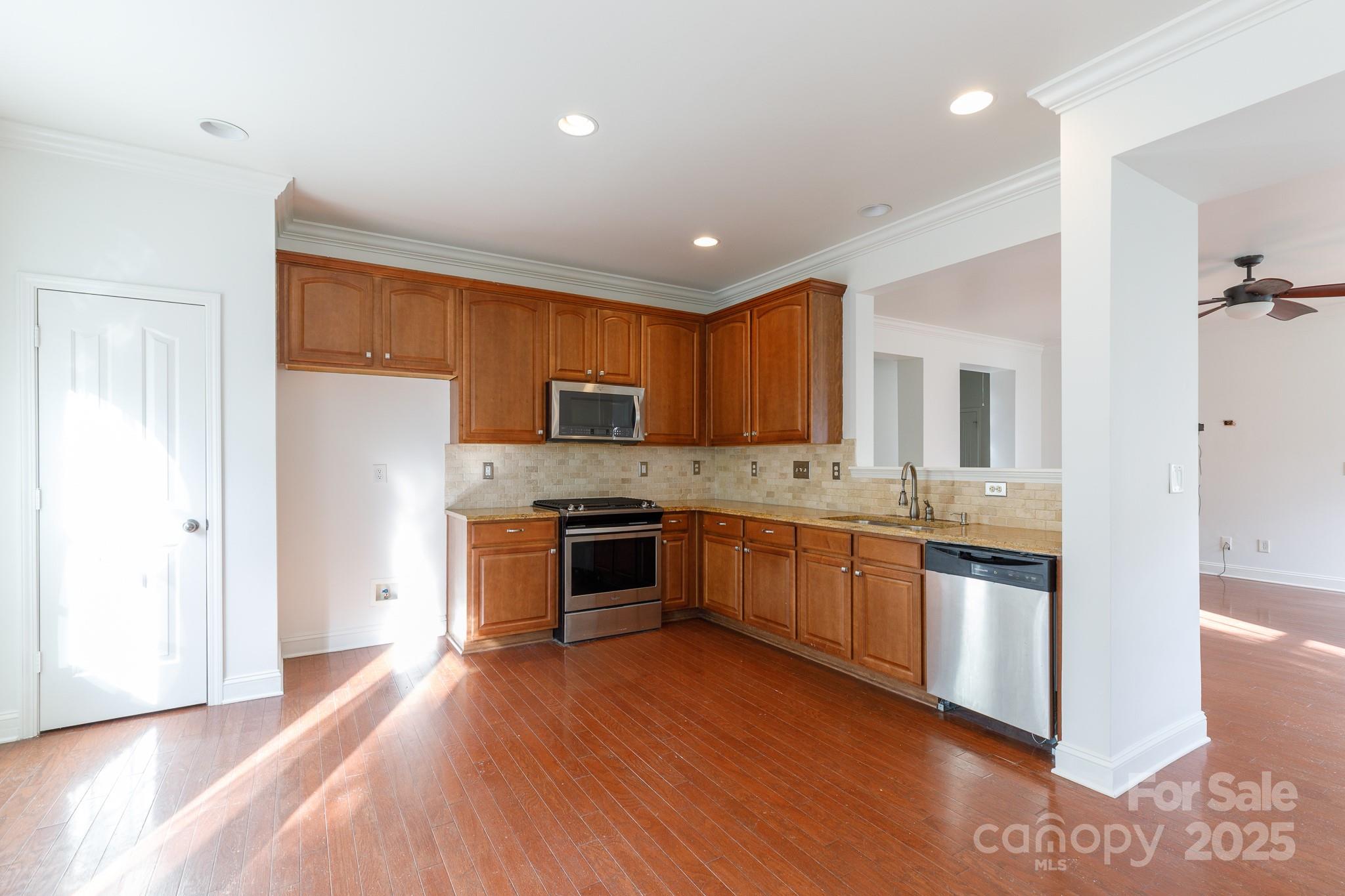 780 Ivy Trail Way Fort Mill, SC 29715 - Photo 5 of 14 a large kitchen with stainless steel appliances granite countertop a stove and a refrigerator
