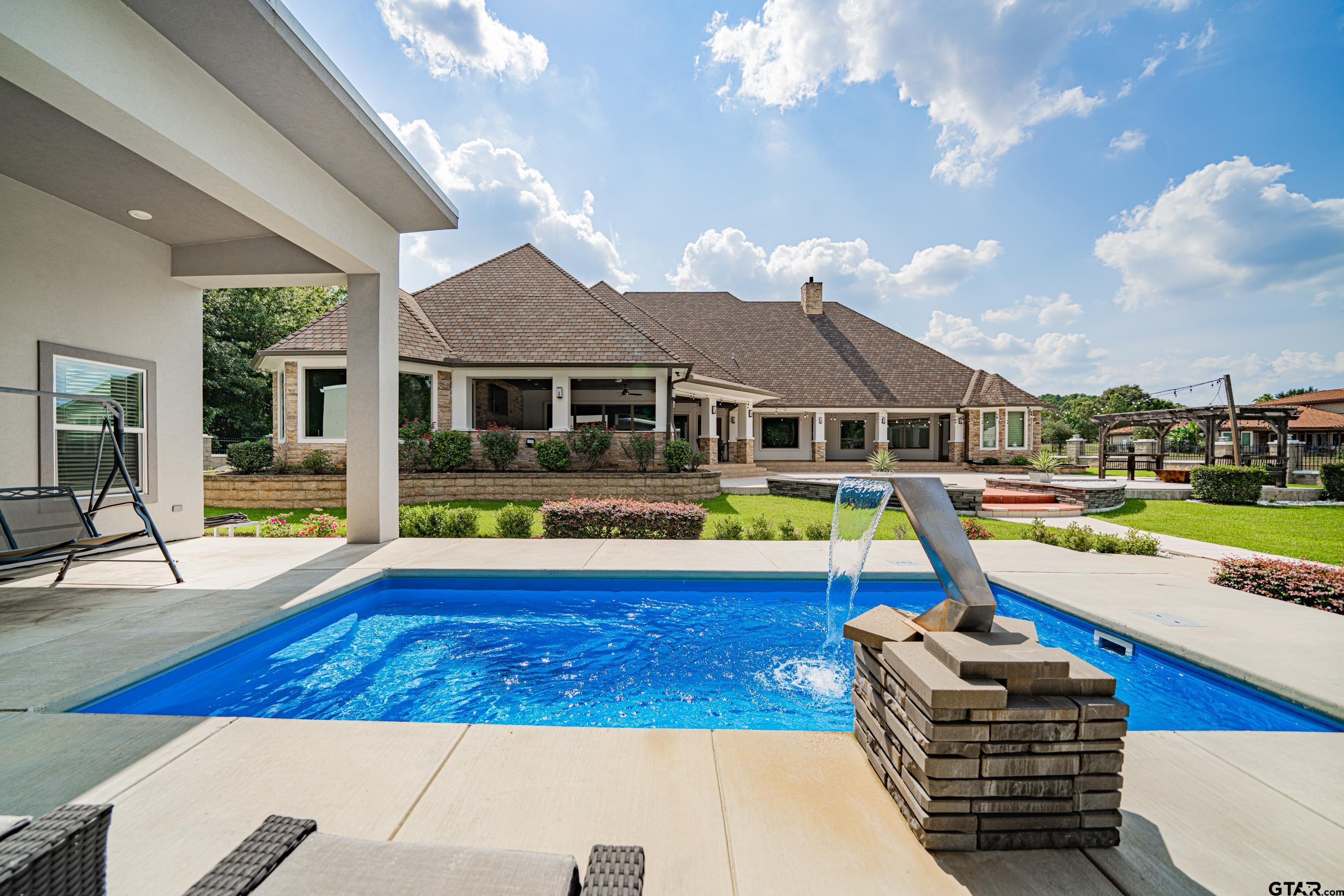 8 Stonebridge Court Longview, TX 75605 - Photo 42 of 48 a view of house with swimming pool outdoor seating