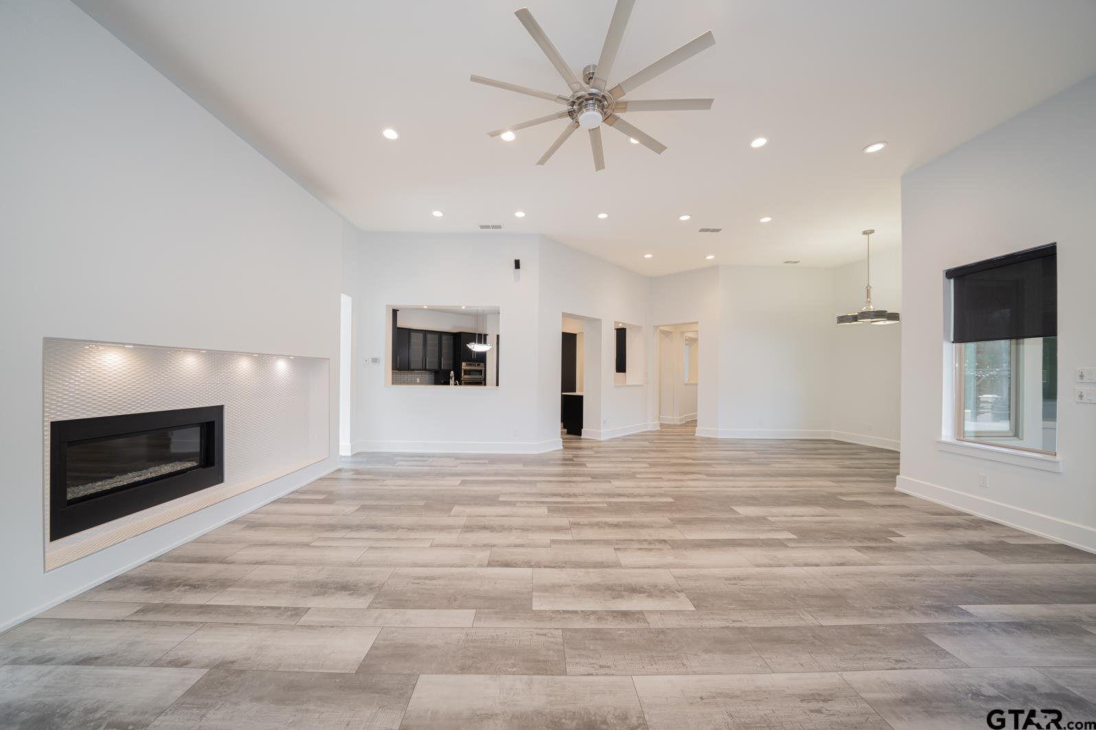 8 Stonebridge Court Longview, TX 75605 - Photo 10 of 48 a view of an empty room with a fireplace and a window