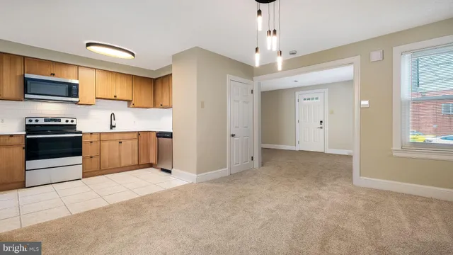 a kitchen with stainless steel appliances granite countertop a stove and a refrigerator