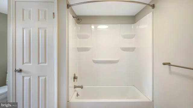 a bathroom with bathtub and shower