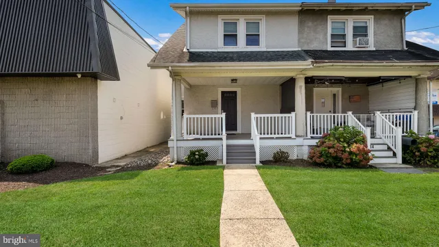 a front view of a house with a garden and plants