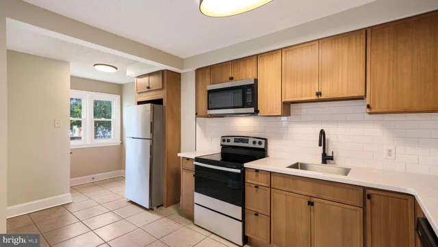 a kitchen with a sink a stove and refrigerator