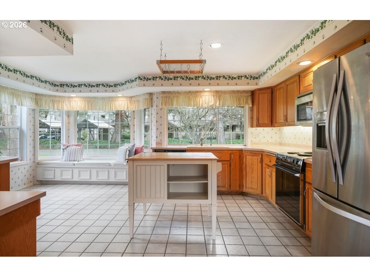 1376 Brickley Road Eugene, OR 97401 - Photo 21 of 48 a kitchen with a refrigerator a sink and a stove