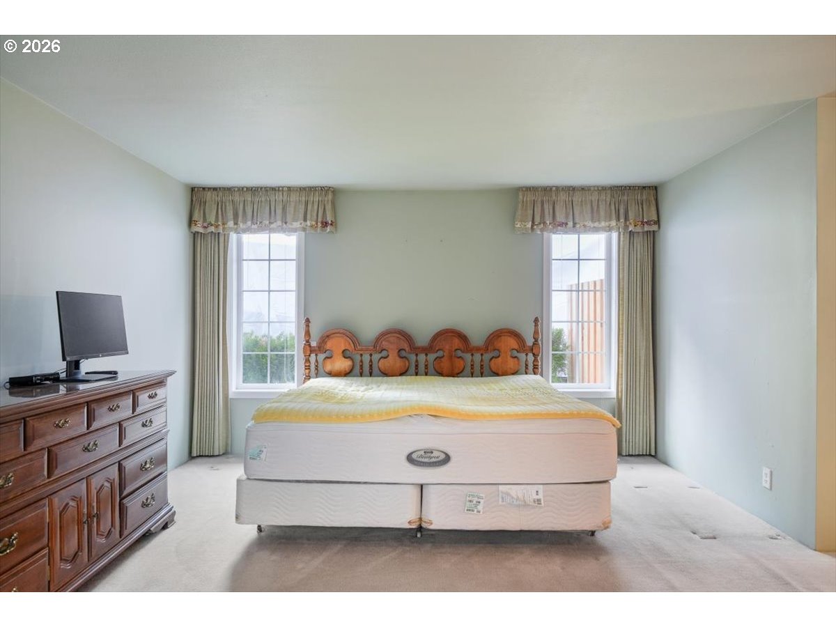 1376 Brickley Road Eugene, OR 97401 - Photo 33 of 48 a bedroom with a bed and a flat screen tv