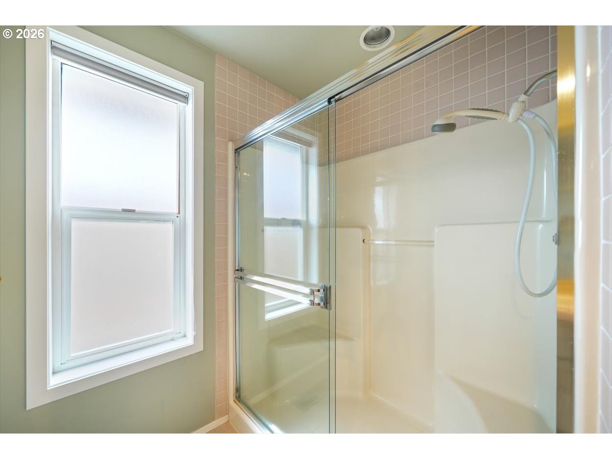 1376 Brickley Road Eugene, OR 97401 - Photo 39 of 48 a bathroom with a glass shower door