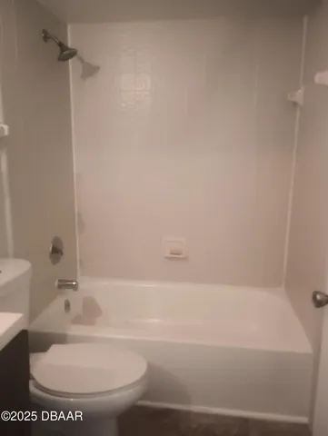 a bathroom with a toilet and a bathtub