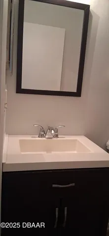 a bathroom with a sink a toilet and a vanity