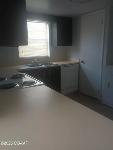 a kitchen with a sink and a window